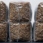 side view of one pound sterilized rye grain six bags to show size